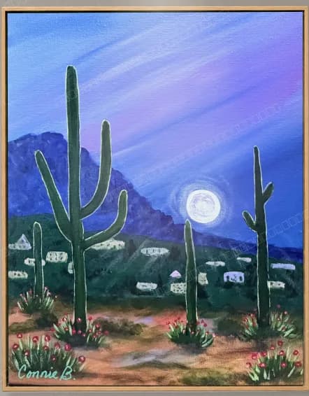 Saguaro cacti under a full moon over desert hills
