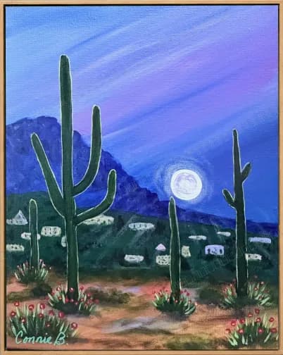 Saguaro cacti under a full moon over desert hills
