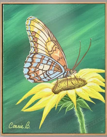 Butterfly resting on a yellow sunflower