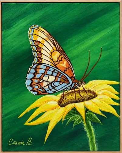Butterfly resting on a yellow sunflower