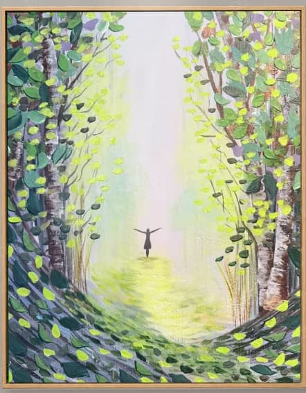 Figure walking a woodland path into a shaft of light