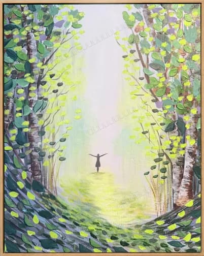 Woodland path opening into light