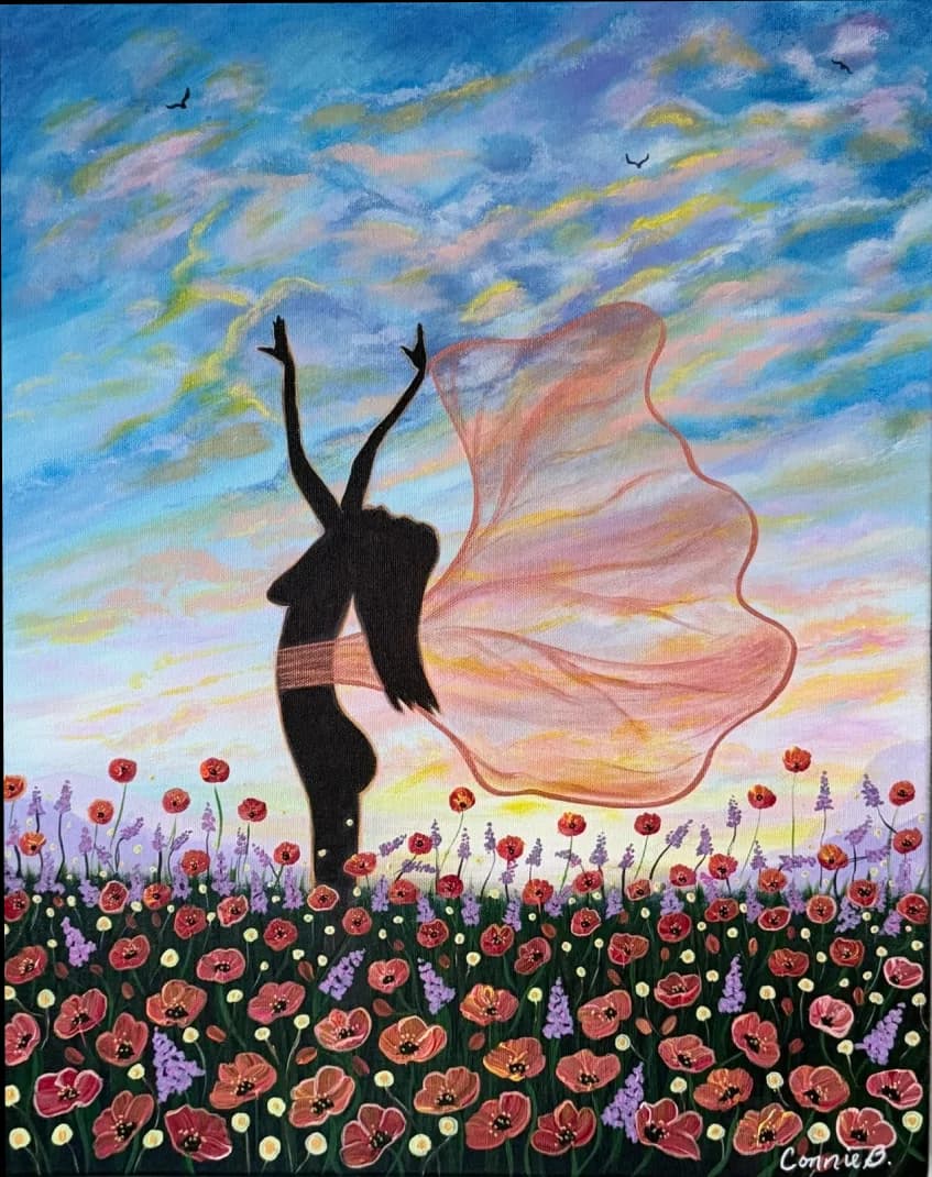 Silhouetted dancer in a poppy field beneath a sunset sky