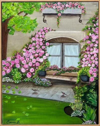 View through a rose-framed window onto a sunlit garden