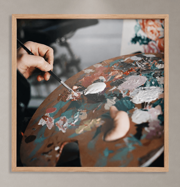 A brush lifting paint from a loaded palette
