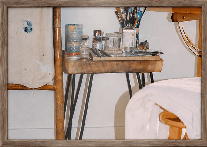 The studio bench with brushes, jars and a work in progress