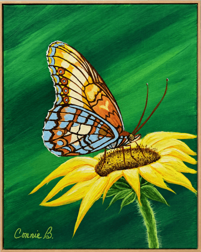 Butterfly resting on a yellow sunflower