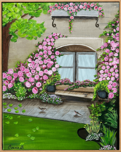 View through a rose-framed window onto a sunlit garden
