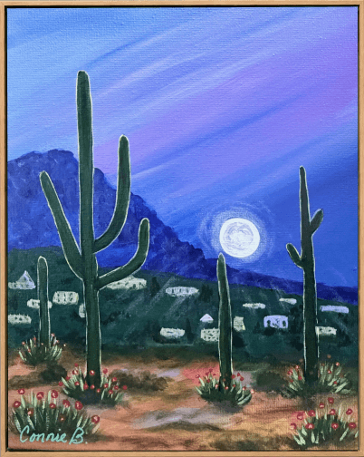 Saguaro cacti under a full moon over desert hills
