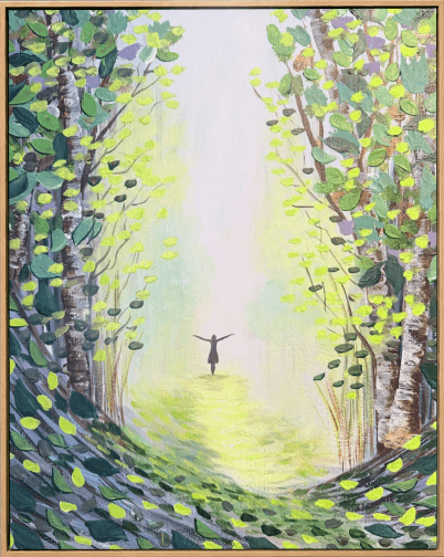 Woodland path opening into light